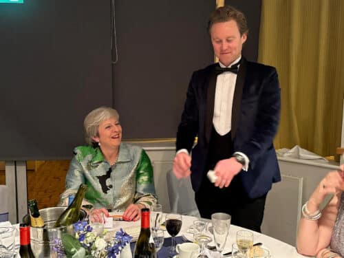 magician-in-tuxedo-performing-magic-on-teresa-may-at-an-event-in-surrey magician-in-tuxedo-performing-magic-on-teresa-may-at-an-event-in-surrey